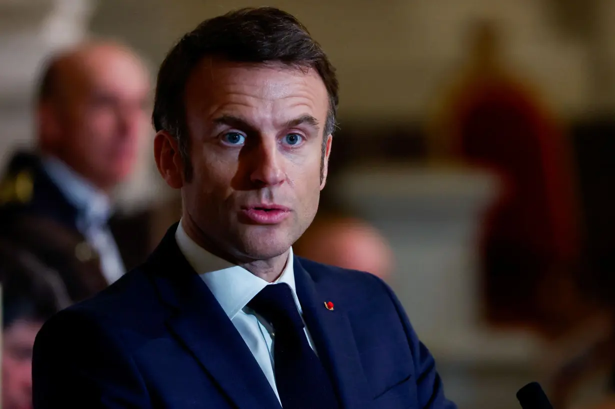 French President Macron and Lithuania's President Nauseda speak before a concert at Saint-Louis des Invalides cathedral in Paris