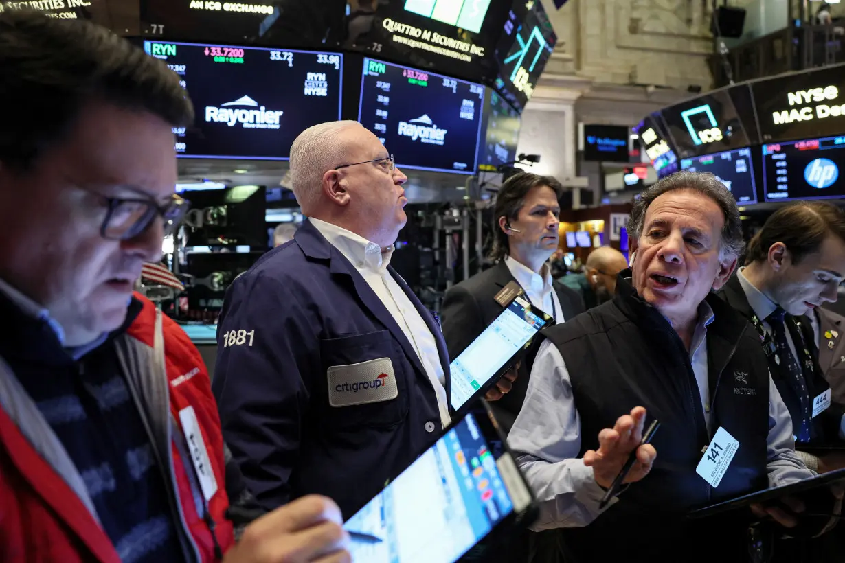 Traders work on the floor of the NYSE in New York