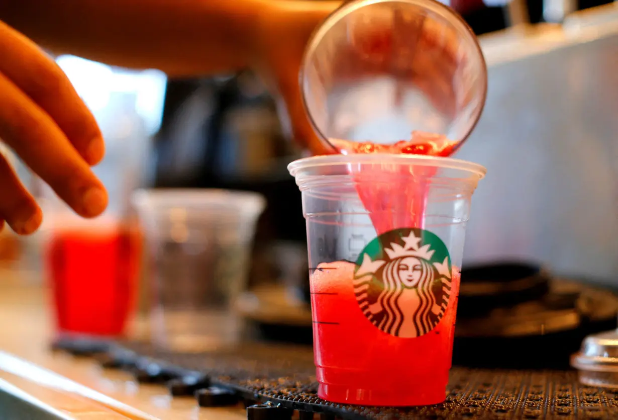 FILE PHOTO: A barista pours a drink at a newly designed Starbucks coffee shop in Fountain Valley, California