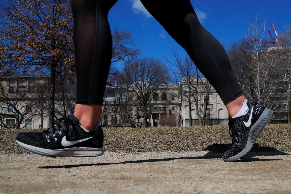A jogger wearing Nike shoes runs in Cambridge