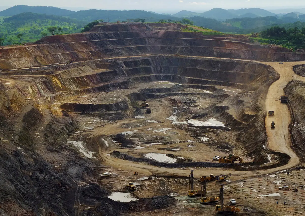 FILE PHOTO: Excavators and drillers at work in an open pit at Tenke Fungurume, a copper and cobalt mine northwest of Lubumbashi in Congo's copper-producing south