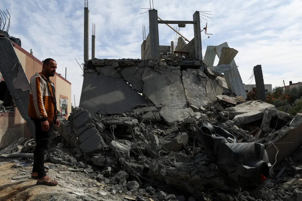 Palestinians gather at the site of an Israeli strike on a house, in Rafah