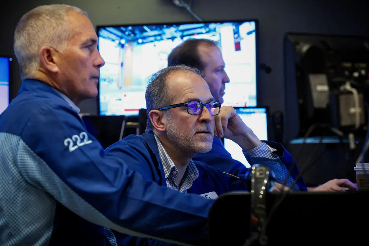 Traders work on the floor of the NYSE in New York