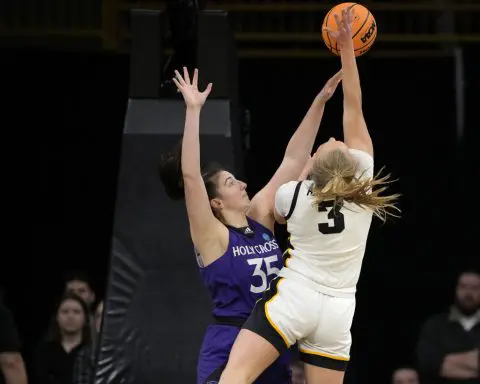 Clark has double-double as No. 1 seed Iowa defeats Holy Cross, 91-65