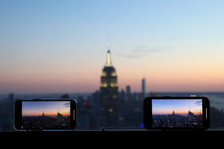 FILE PHOTO: Smartphones are used to record the skyline at sunset in Manhattan, in New York City