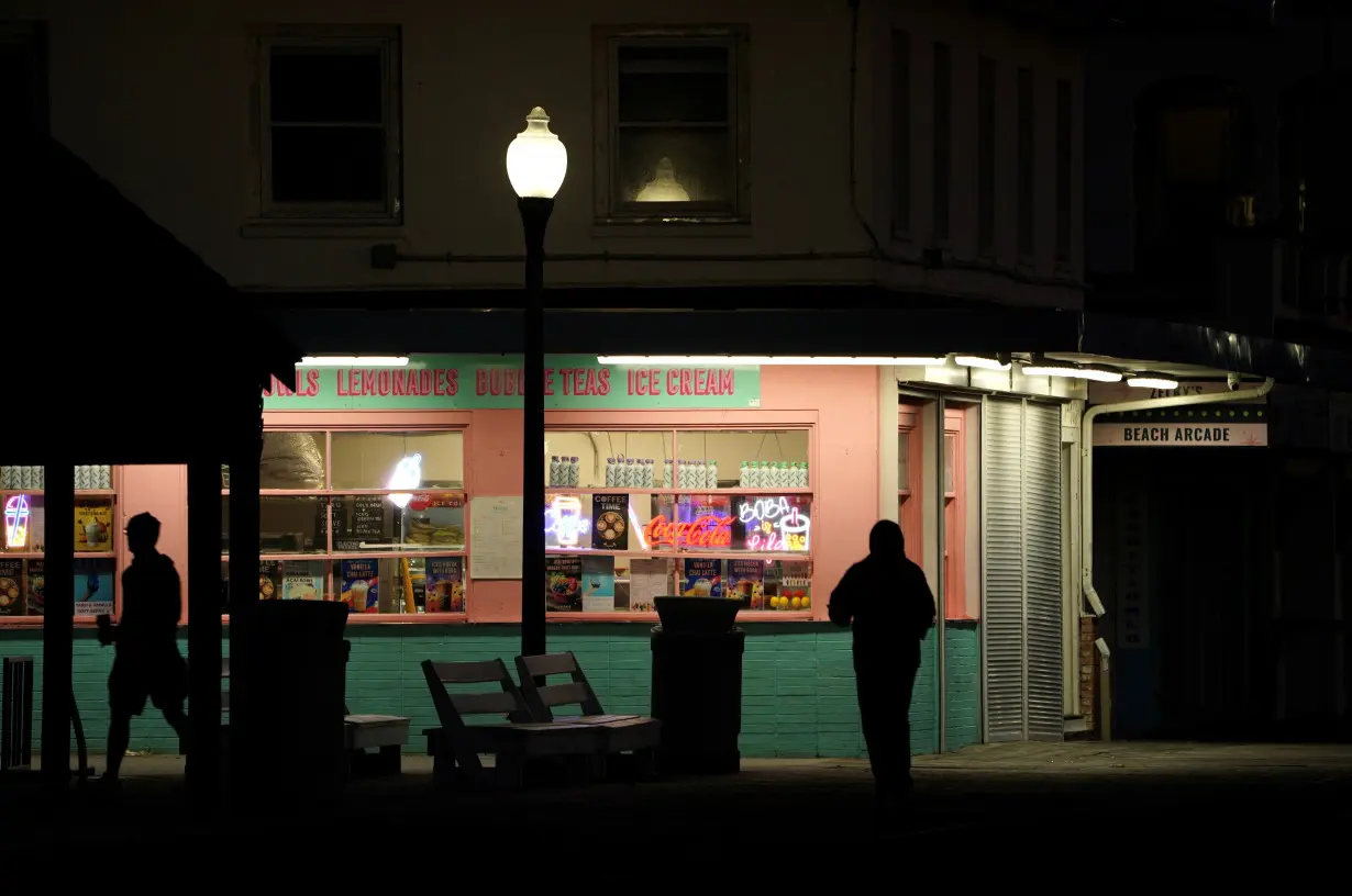 People at the boardwalk in Rehoboth Beach at dawn