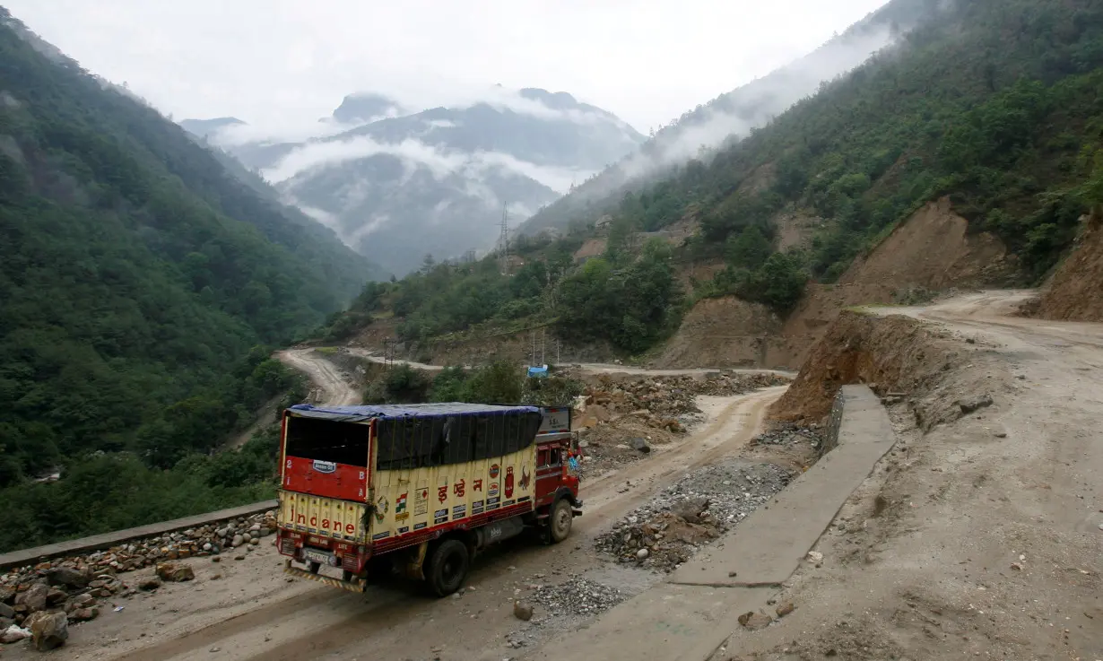 FILE PHOTO: A liquefied petroleum gas delivery truck drives along India's Tezpur-Tawang highway which runs to the Chinese border, in the northeastern Indian state of Arunachal Pradesh