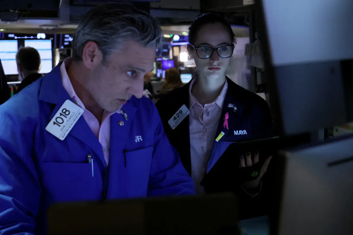 Traders work on the floor of the NYSE in New York