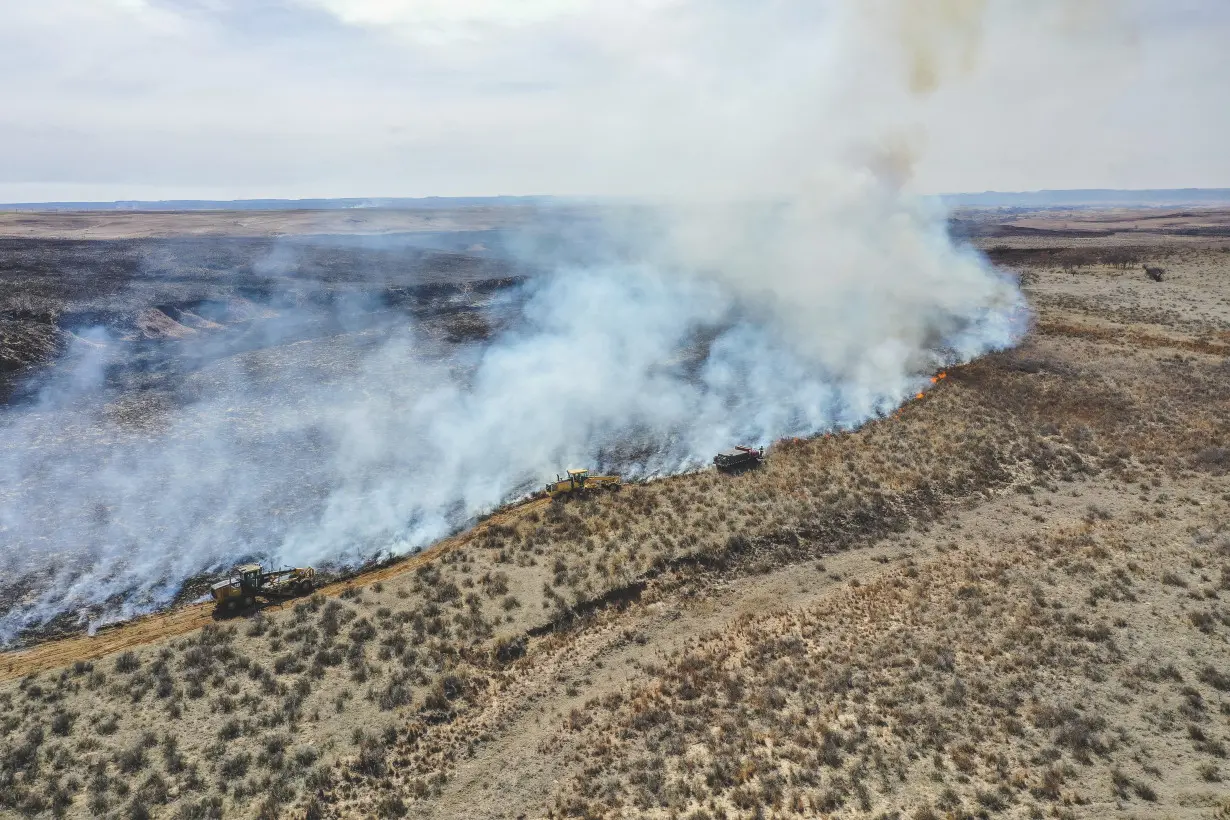 Texas firefighters battle flames stoked by strong winds as warnings are issued across the region