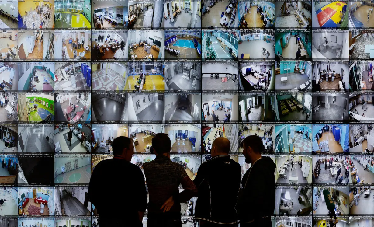 People look at the screens at the headquarters of Russia's Central Election Commission, in Moscow