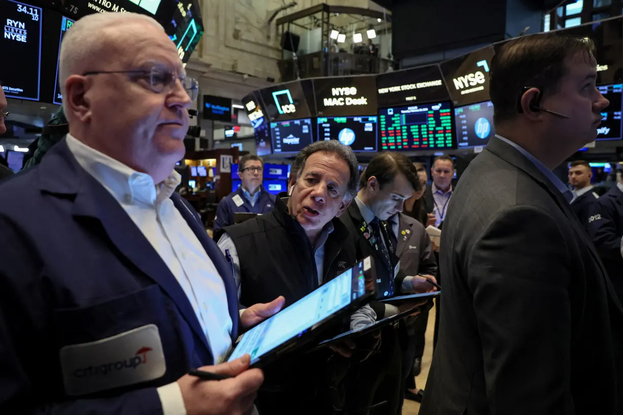 Traders work on the floor of the NYSE in New York