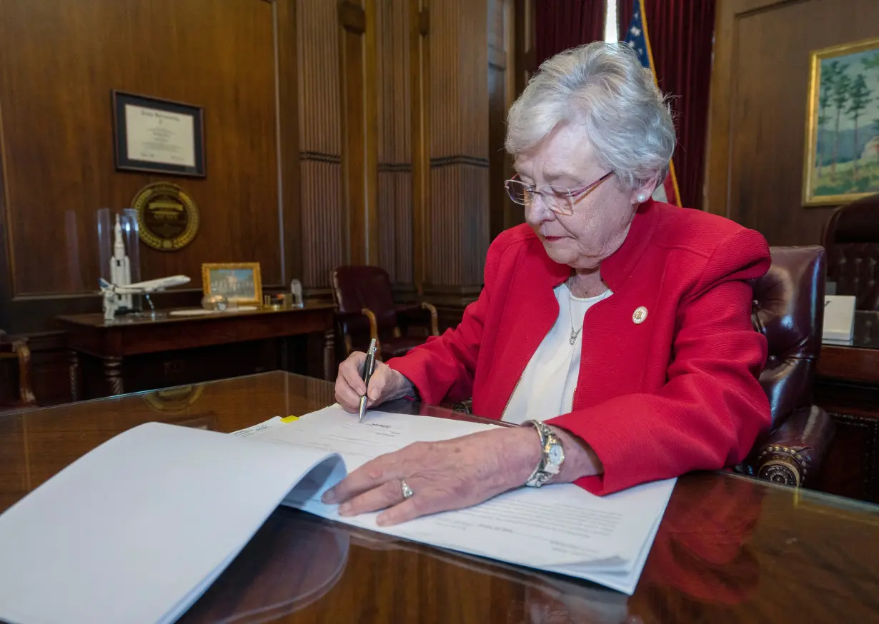 FILE PHOTO: Handout photo of Alabama Governor Kay Ivey signing into law the Alabama Human Life Protection Act in Montgomery