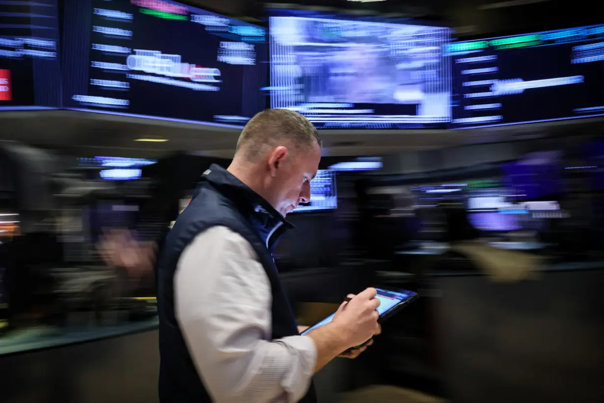 Traders work on the floor of the NYSE in New York