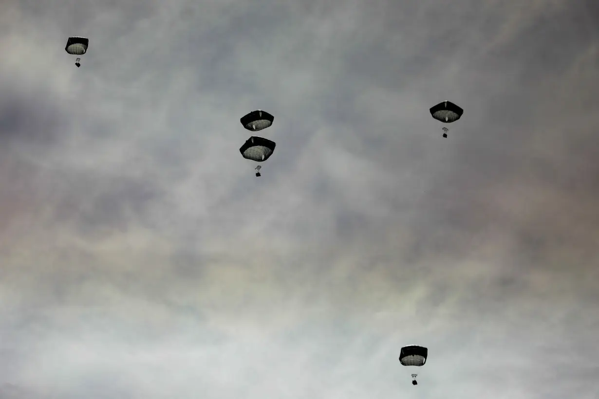 Aid is air-dropped over Gaza, amid the ongoing the conflict between Israel and Hamas, in Gaza City