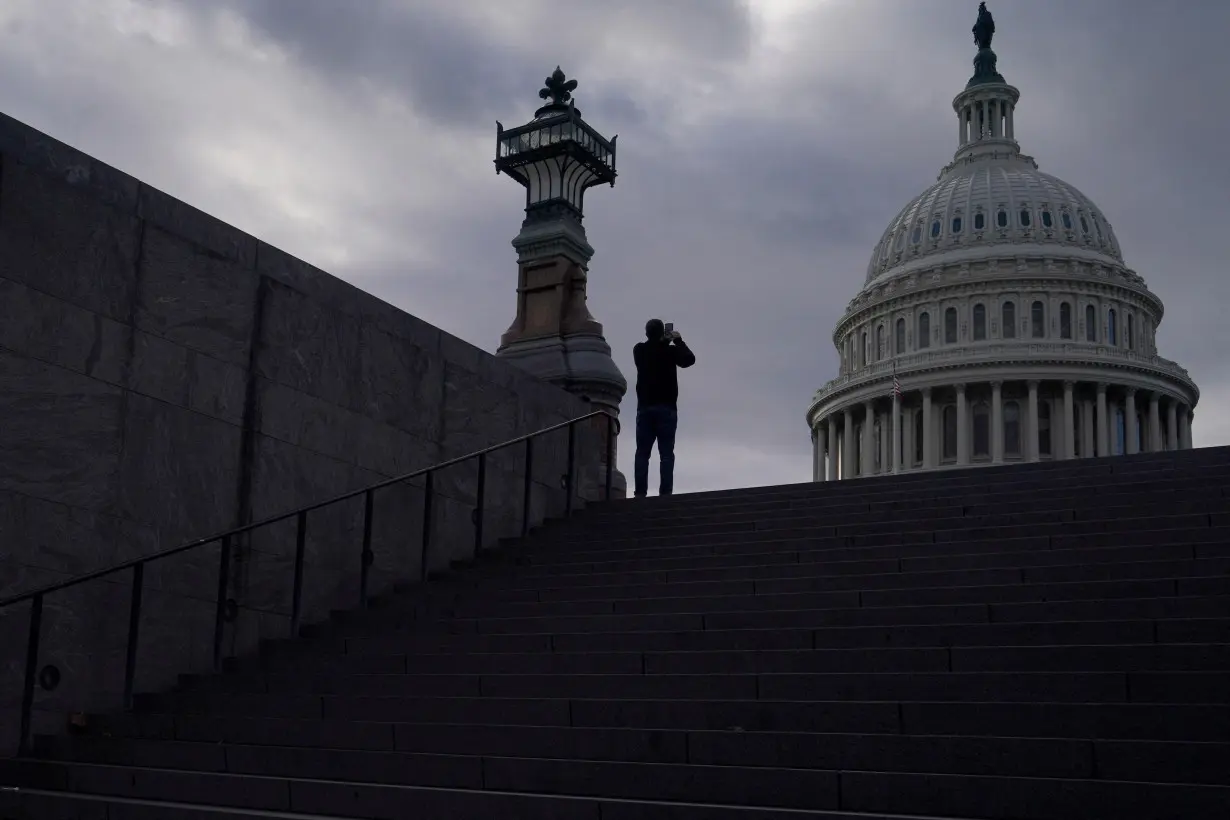 FILE PHOTO: A man uses his mobile phone near the U.S. Capitol in Washington