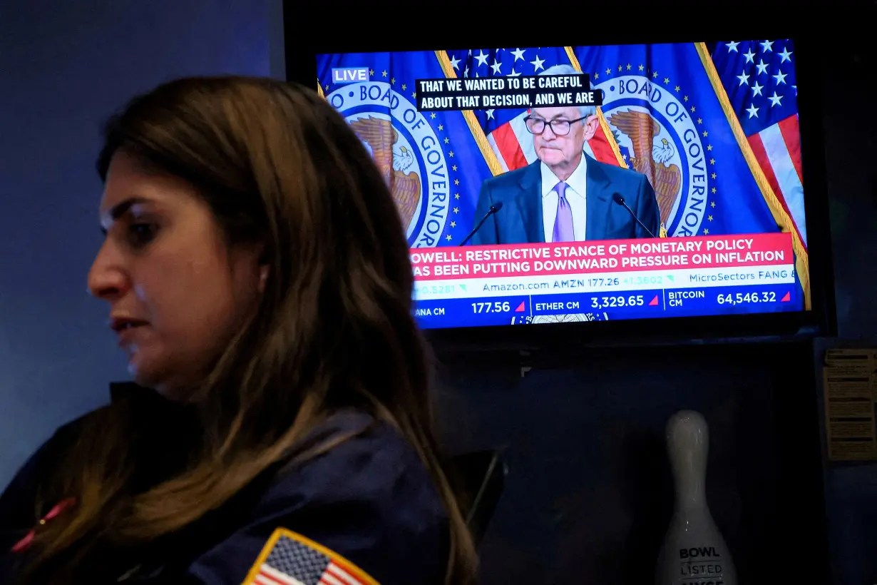 FILE PHOTO: Traders reacts to Fed rate announcement on the floor of the NYSE in New York