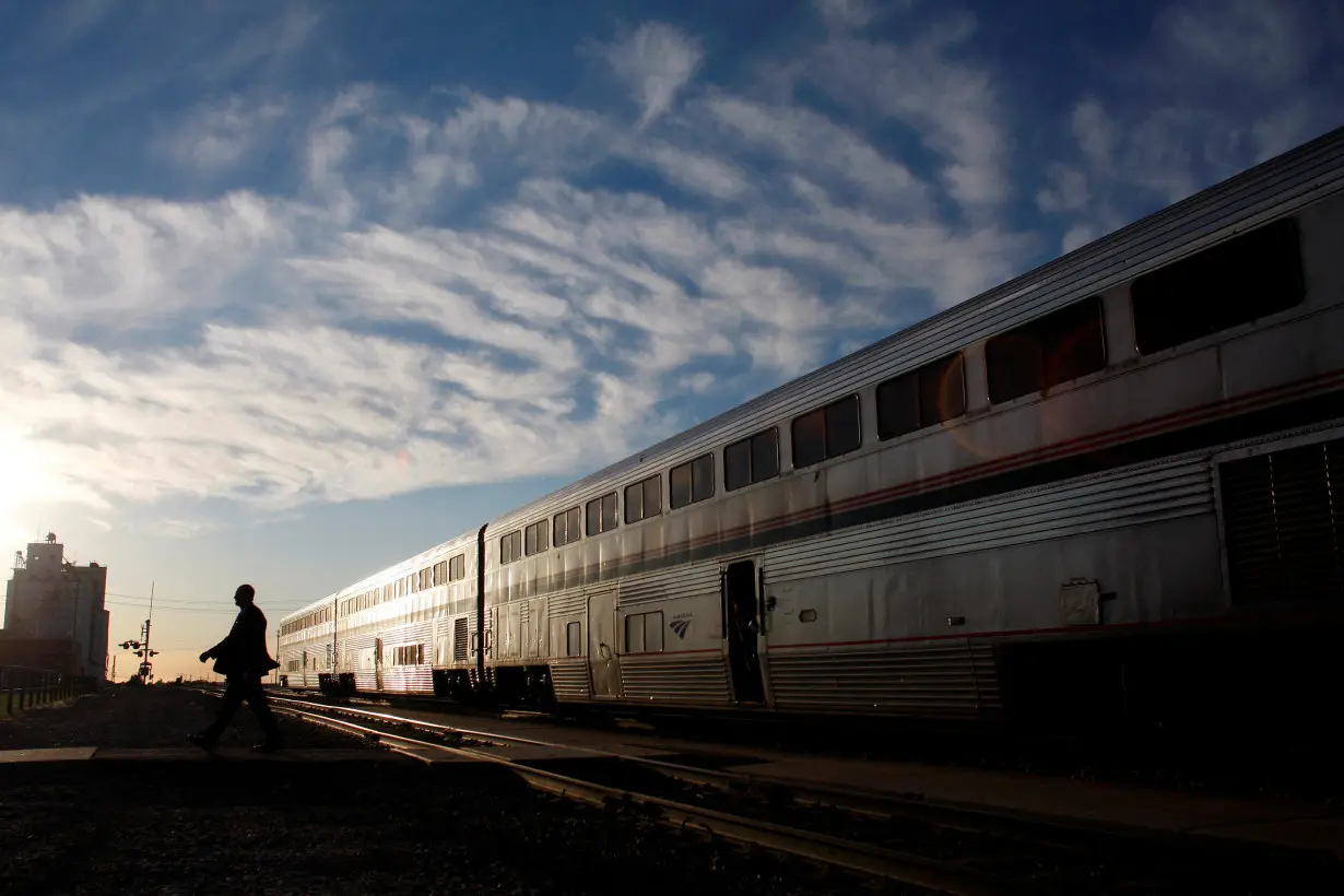 FILE PHOTO: An Amtrak train attendant walks across the tracks at the Holdrege station
