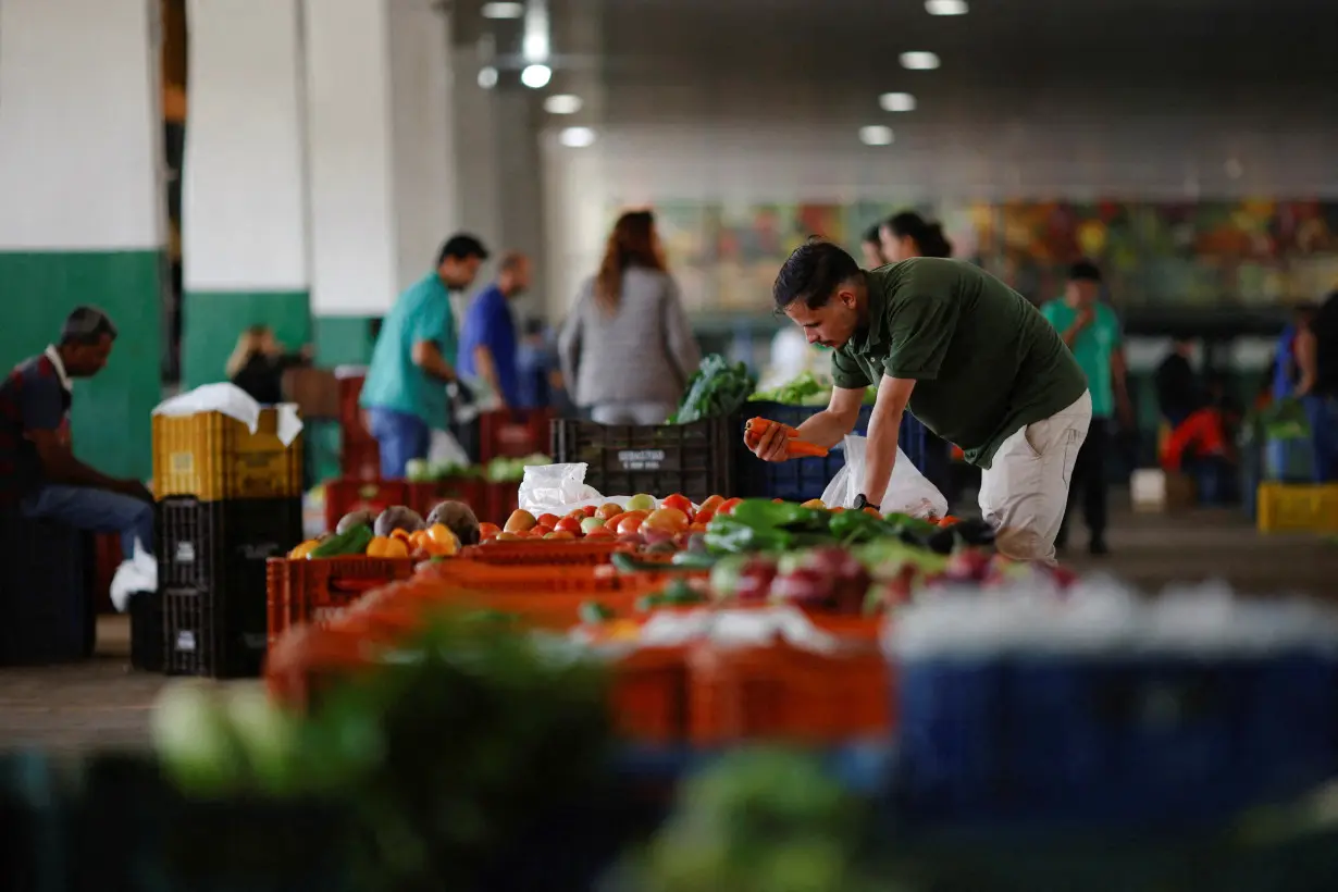 FILE PHOTO: A salesman is seen at his vegetable stand at the supply centre (CEASA) in Brasilia