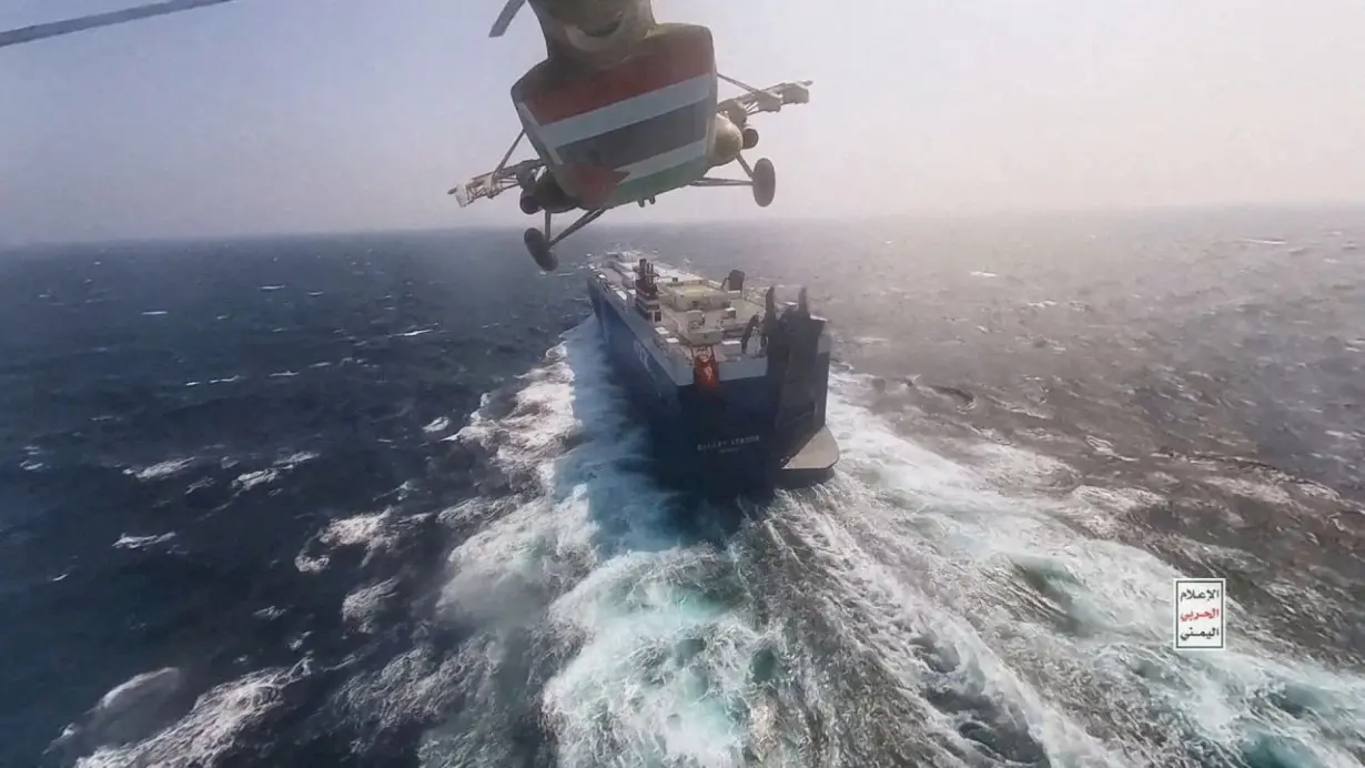 FILE PHOTO: Houthi military helicopter over the Galaxy Leader cargo ship in the Red Sea