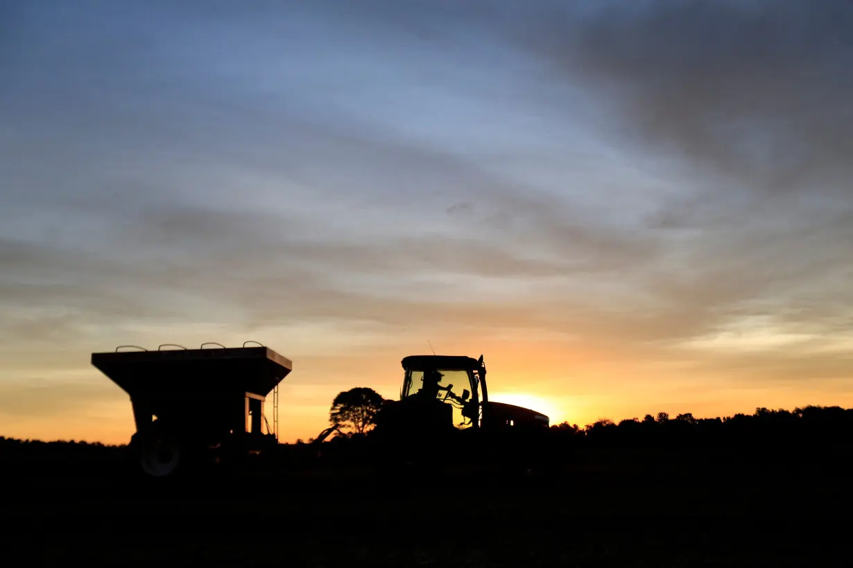 FILE PHOTO: Tractor is silhouetted after harvesting soybeans at a farm in Caaguazu