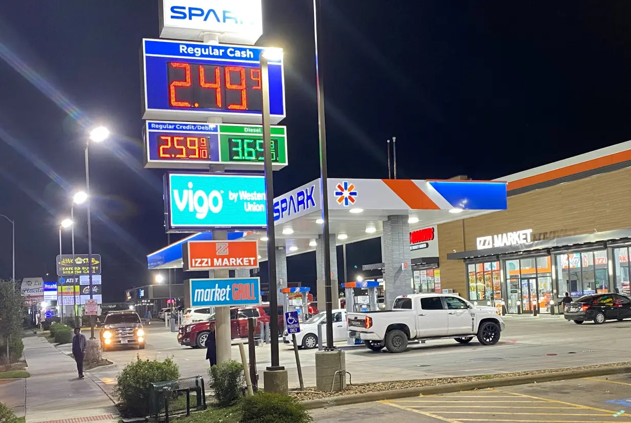 Signage shows the price of unleaded regular gas at less than $2.50 per gallon, in Houston