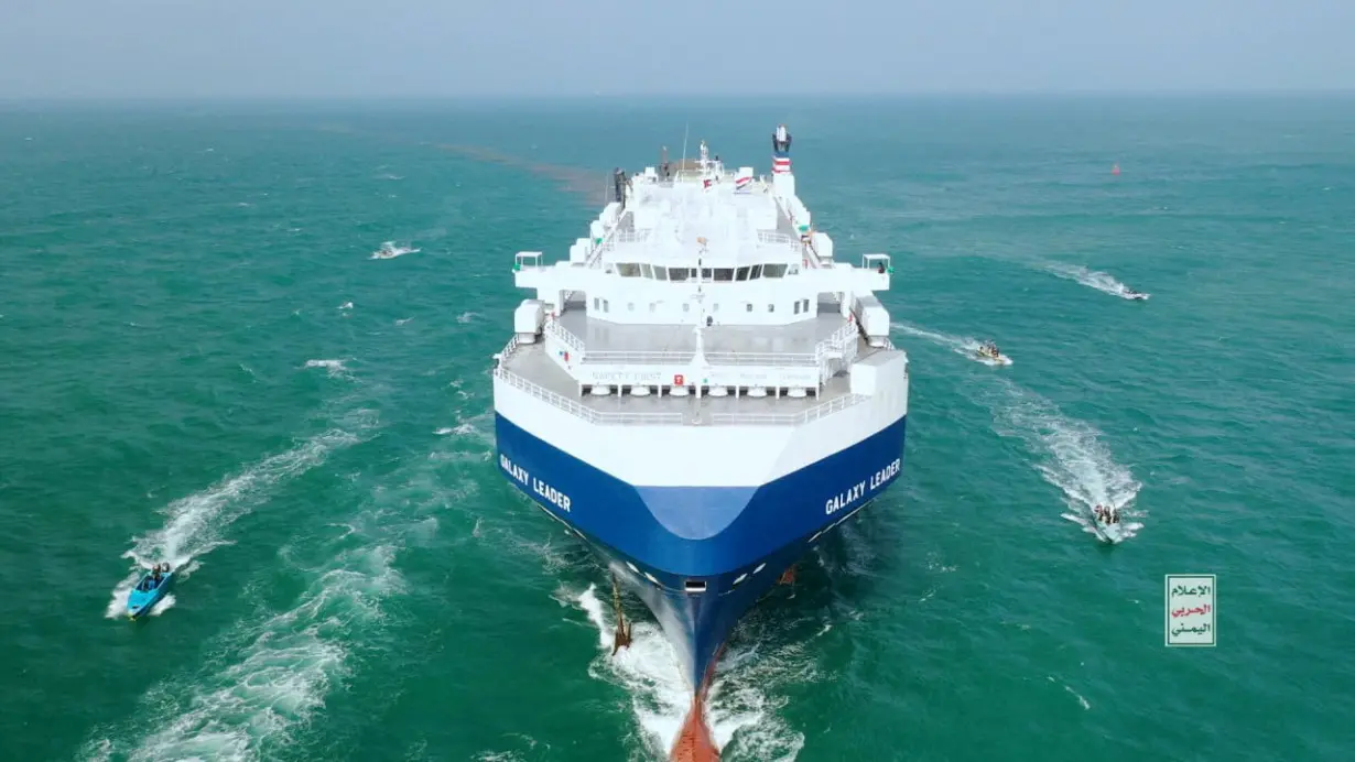 FILE PHOTO: The Galaxy Leader cargo ship is escorted by Houthi boats in the Red Sea