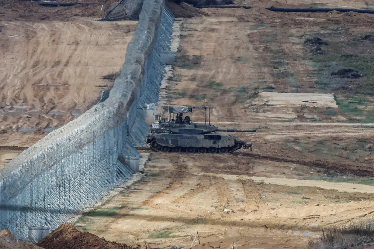 An Israeli Merkava tank manoeuvres near the Israel-Gaza border, amid the temporary truce between Hamas and Israel, as seen from southern Israel