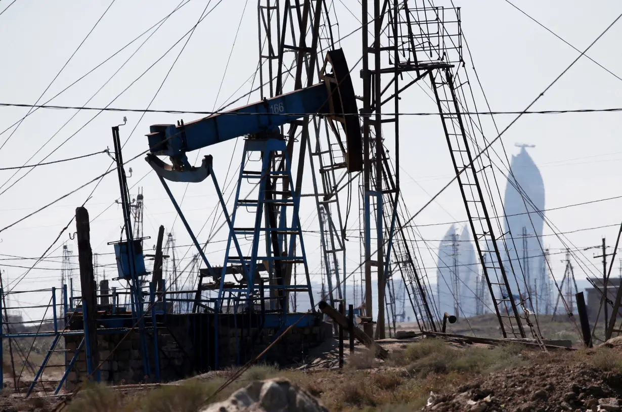 FILE PHOTO: A nodding donkey pumps oil in an oil field in the settlement of Balaxani