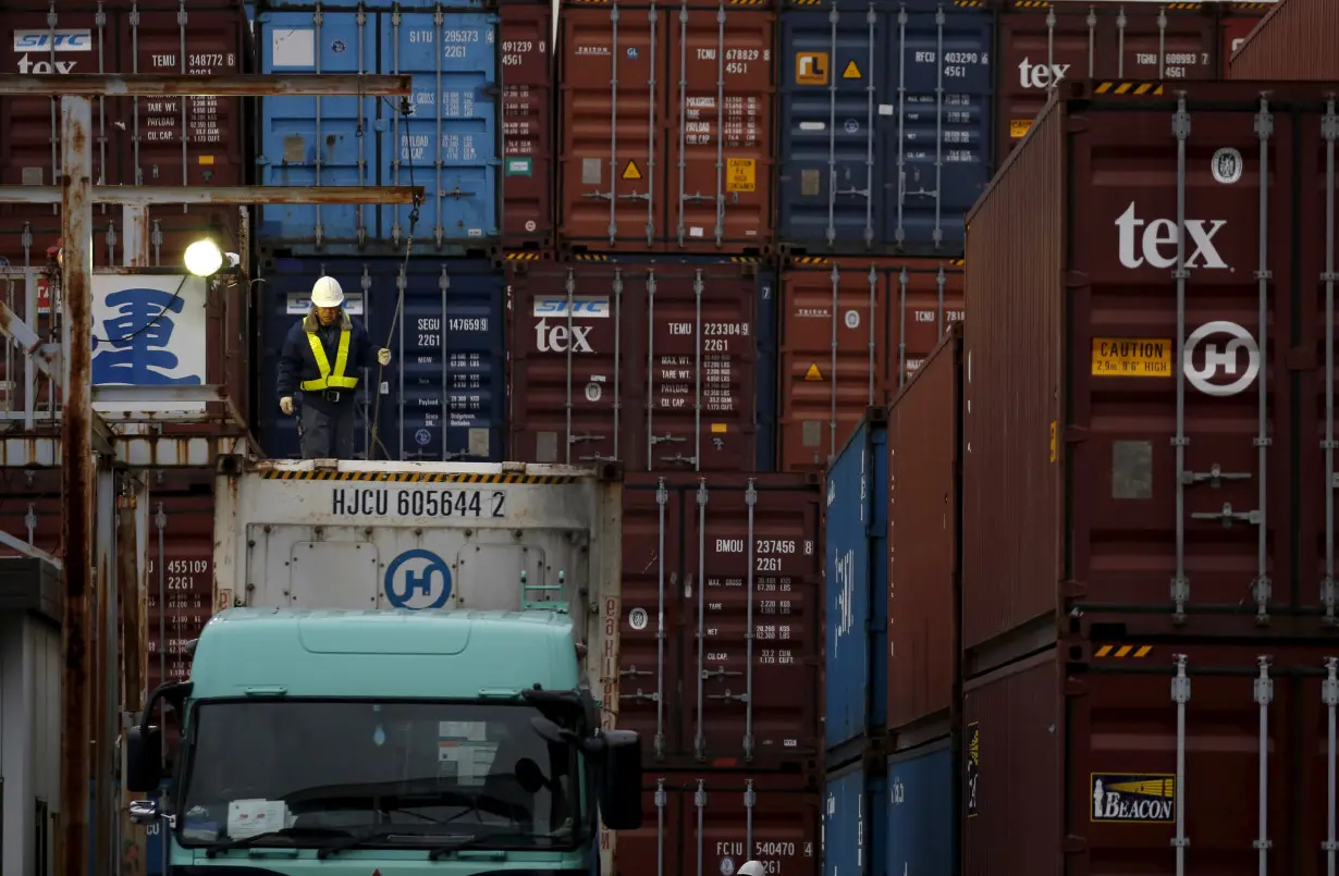 A laborer works in a container area at a port in Tokyo