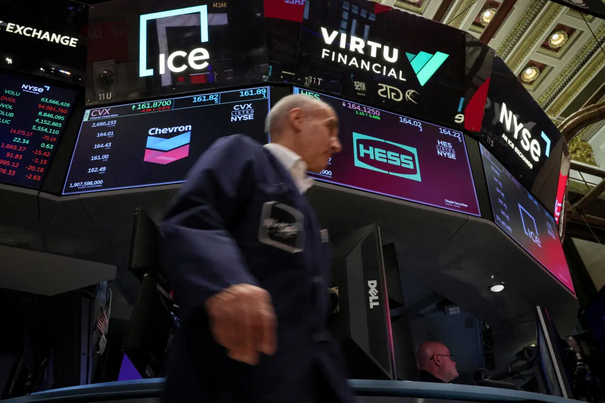 FILE PHOTO: Traders work on the floor of the NYSE in New York