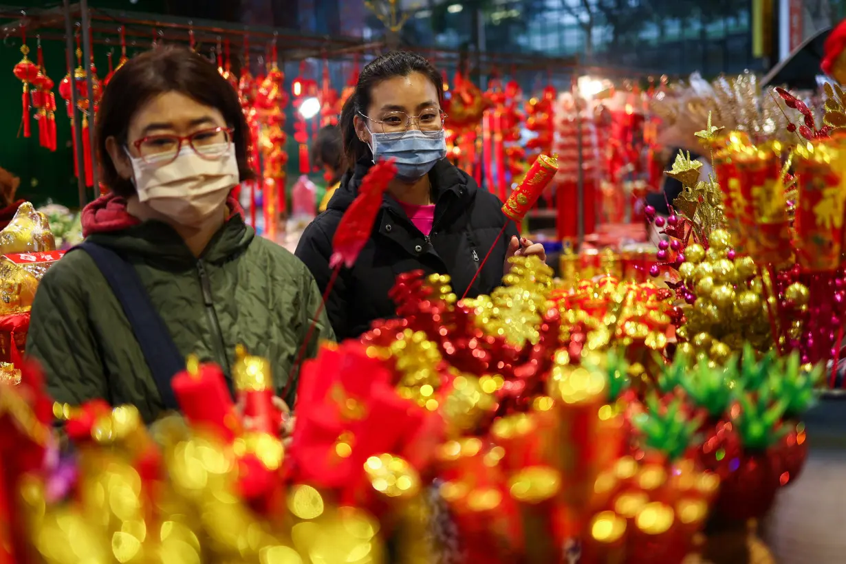 People shop at a flower market in Taiwan in preparation for Lunar New Year celebrations