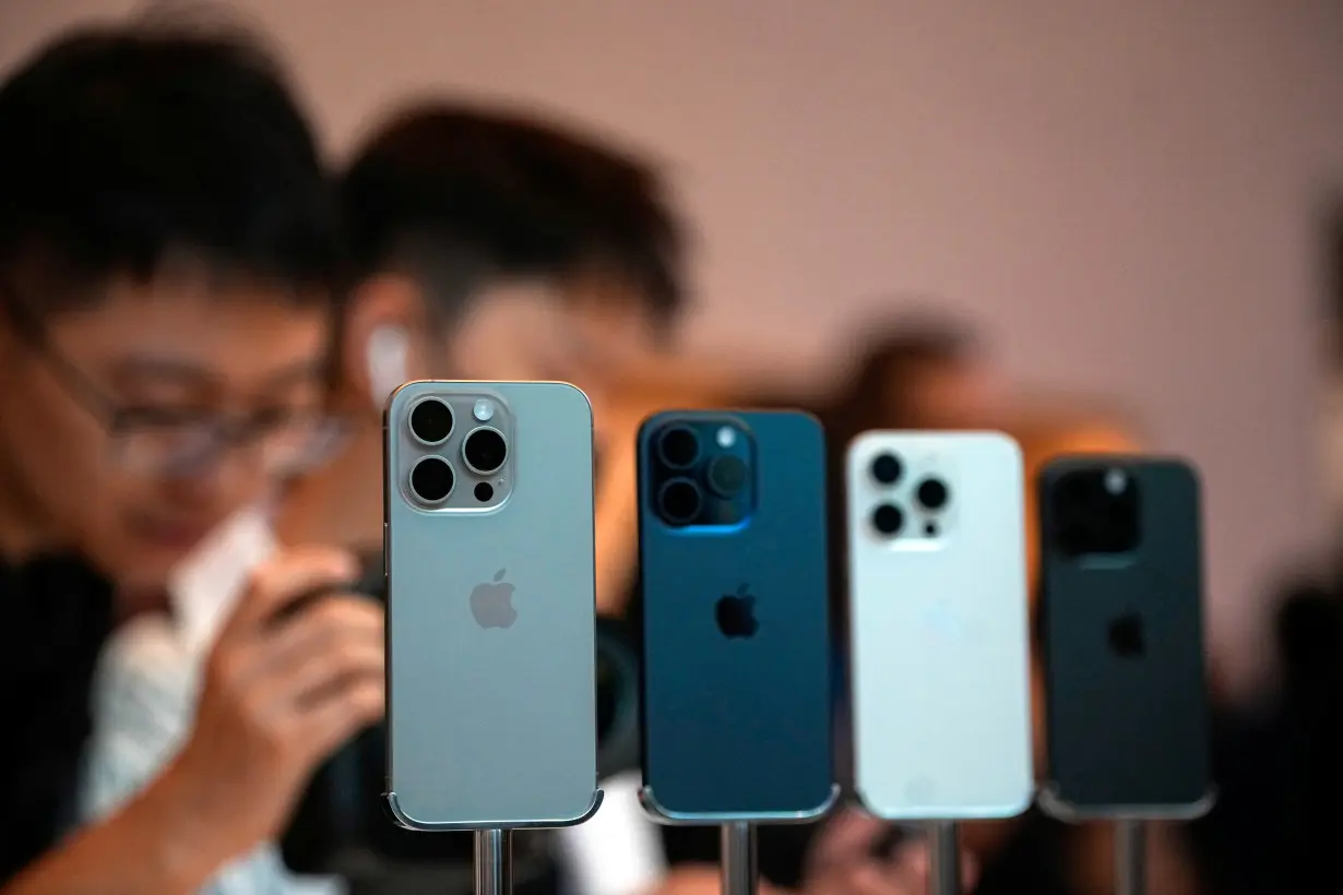 People look at the new iPhone 15 Pro as Apple's new iPhone 15 officially goes on sale across China at an Apple store in Shanghai