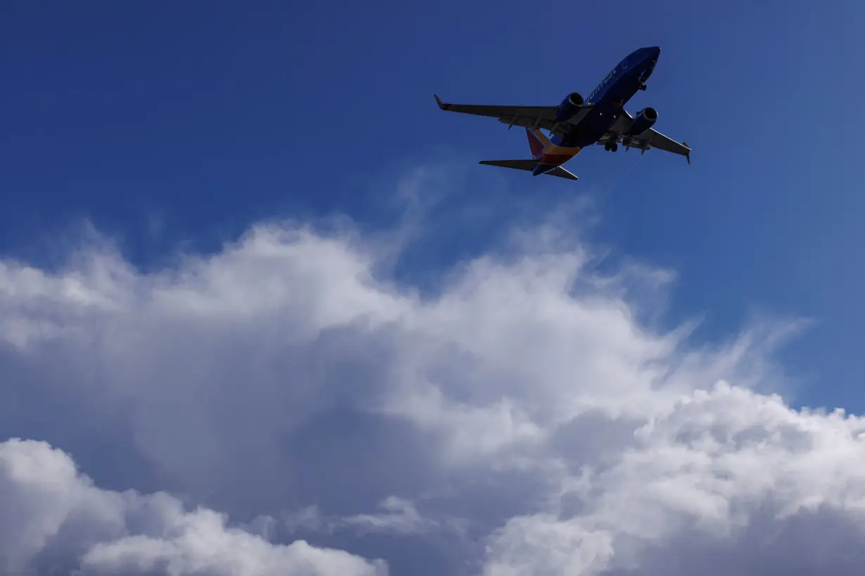 FILE PHOTO: A Southwest Airlines flight descends past stpmy sky in California