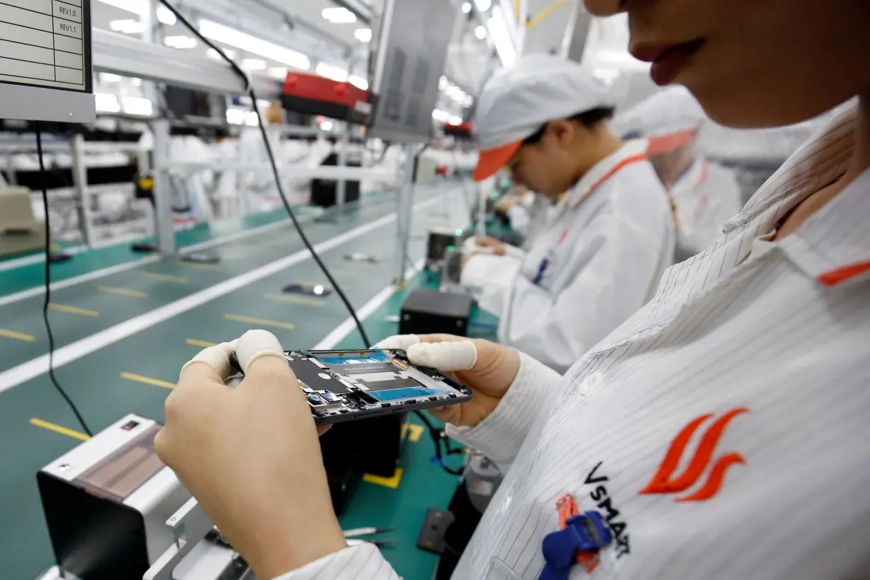 FILE PHOTO: A manufacturer works at an assembly line of Vingroup's Vsmart phone in Hai Phong