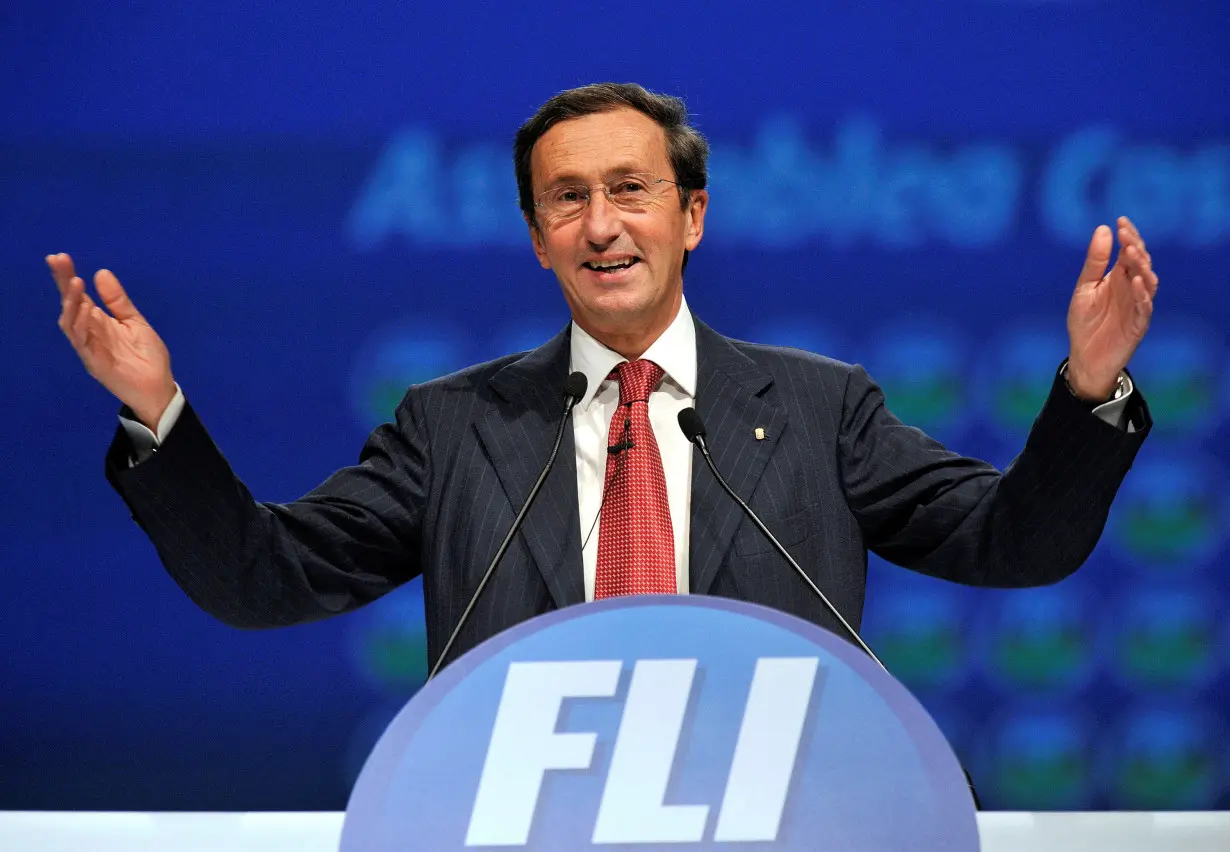 FILE PHOTO: Gianfranco Fini gestures as he delivers his speech at the first meeting of his new political party 'Futuro e Liberta' in Milan