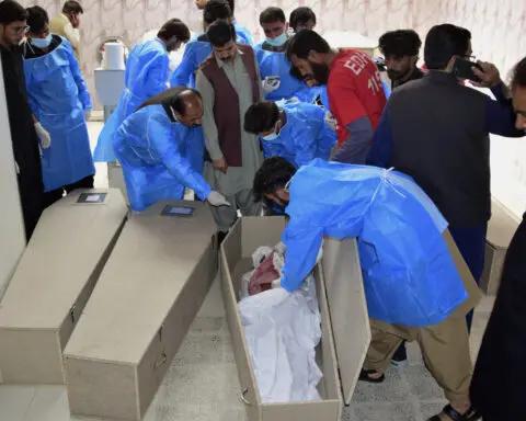 Pakistani police search for gunmen who abducted bus passengers and killed 10 in the southwest
