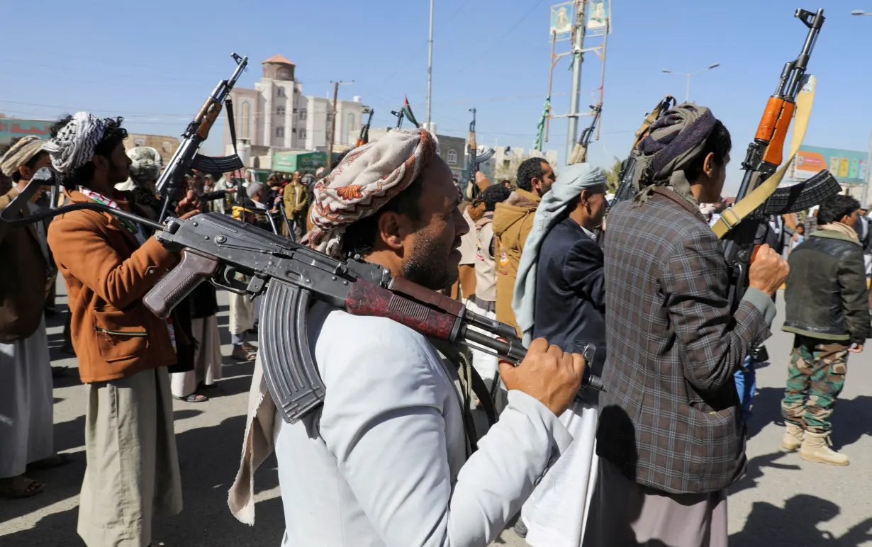 FILE PHOTO: Newly recruited Houthi fighters hold up firearms during a ceremony at the end of their training in Sanaa