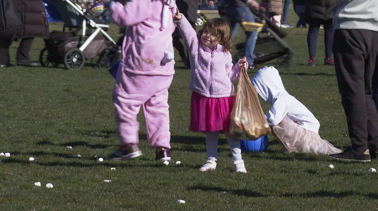 Children race to collect marshmallows dropped from a helicopter at a Detroit-area park