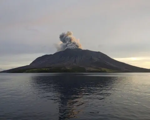 Airport near volcano reopens as Indonesia lowers eruption alert level