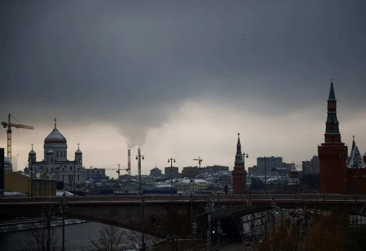 Steam rises from chimneys of a heating power plan over the skyline of central Moscow