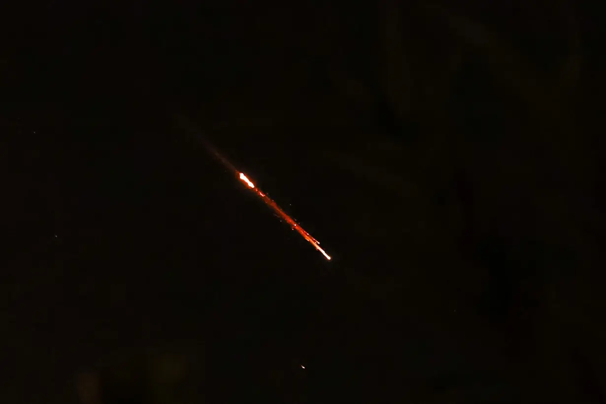 Objects are seen in the sky above Jerusalem after Iran launched drones and missiles towards Israel, in Jerusalem