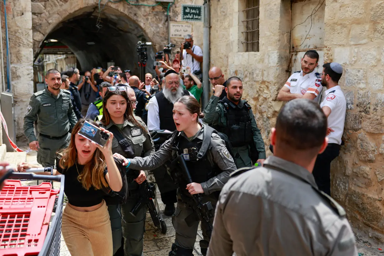 Israeli emergency responders work at the scene of a stabbing attack, in Jerusalem