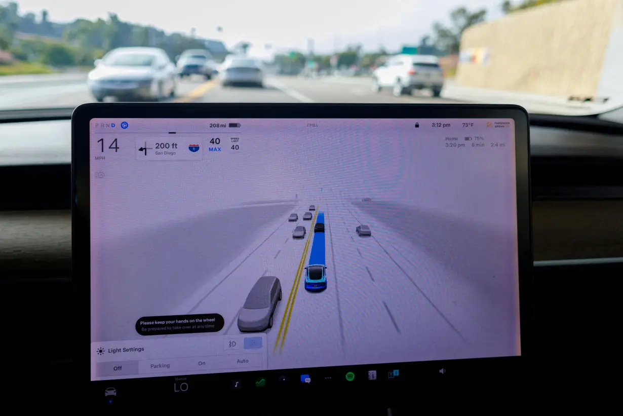 FILE PHOTO: Tesla Model 3 vehicle self driving in California