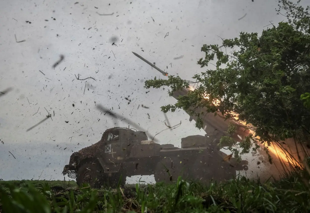 FILE PHOTO: Ukrainian servicemen fire a BM-21 Grad multiple launch rocket system towards Russian troops in Donetsk region