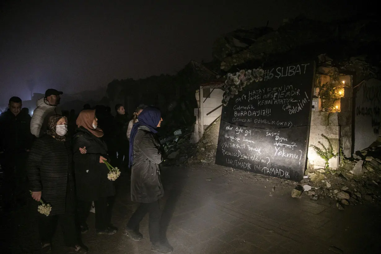 Turkey mourns tens of thousands dead, surrounded by the ruins of last year's earthquake