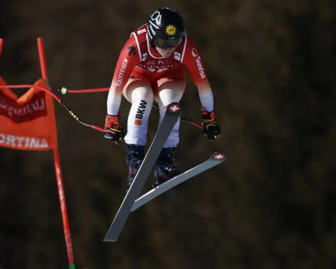 Shiffrin gets up after losing control and crashing while landing a jump in a World Cup downhill