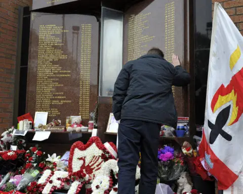 The UK apologizes to families of 97 Liverpool soccer fans killed in a stadium crush 34 years ago