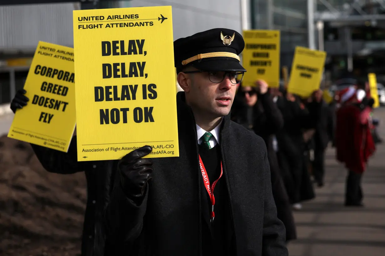 Demonstrators participate in the United Flight Attendants nationwide demonstration to demand fair contract outside LaGuardia Airport in New York City