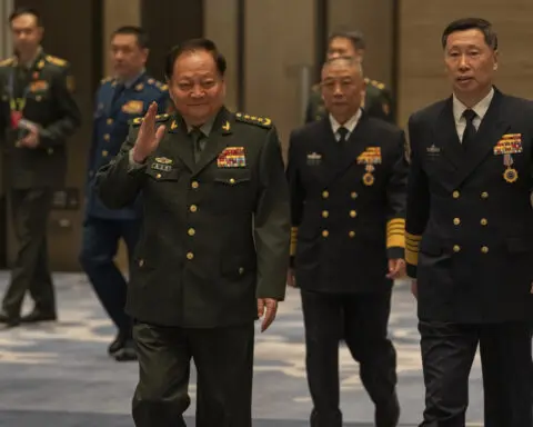 Chinese general takes a harsh line on Taiwan and other disputes at an international naval gathering