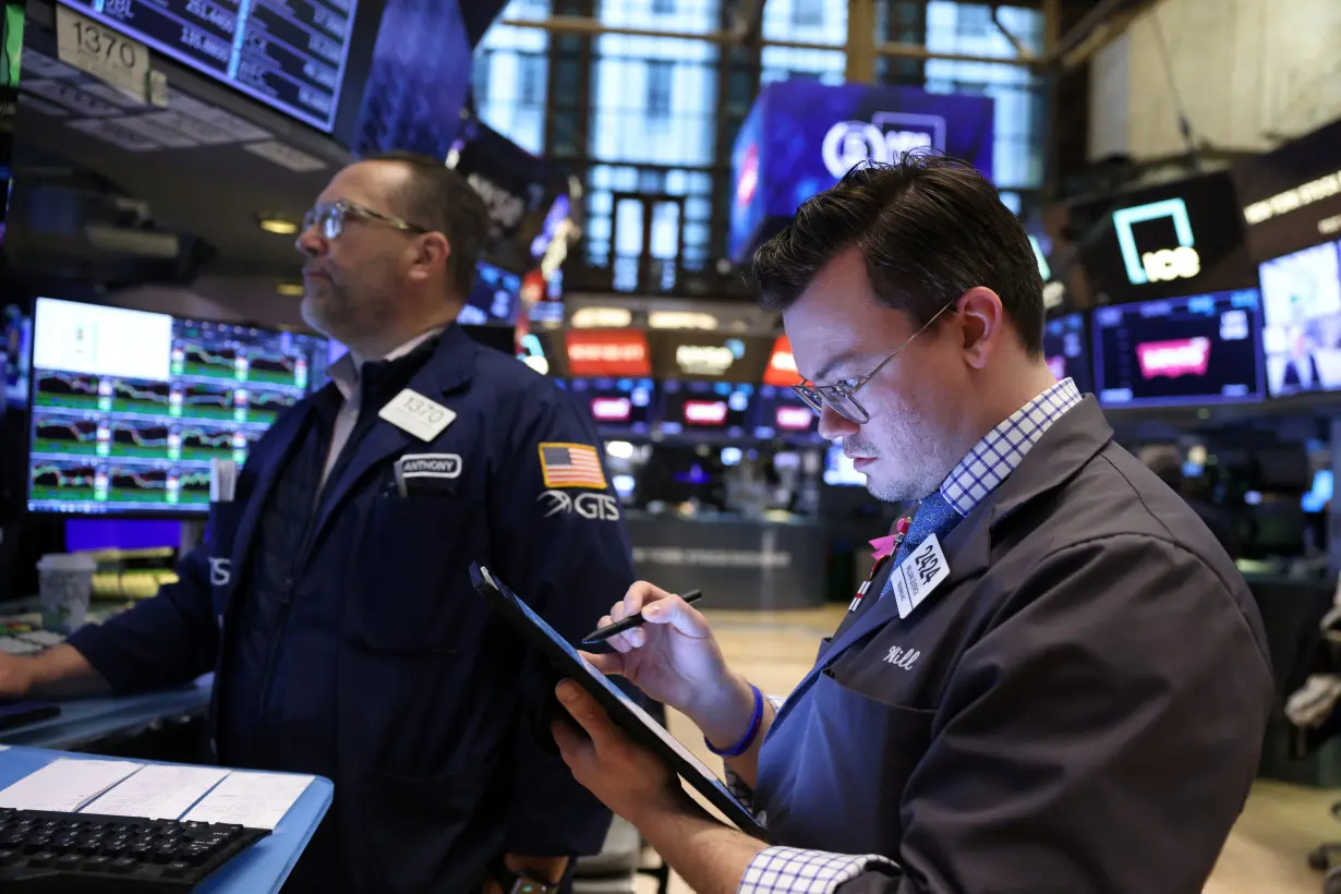 Traders work on the trading floor at the New York Stock Exchange (NYSE) in New York City